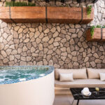 Suite 102 lower-level outdoor hot tub at The Cosmopolitan Karterados Urban Suites